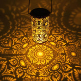 Decorative lantern casting mandala patterns on a textured surface